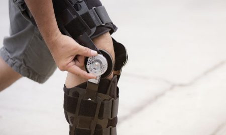 Men wearing a knee support belt Concept of care for osteoarthritis
